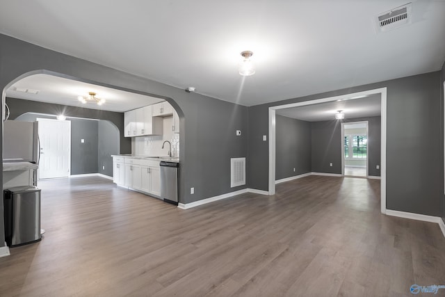 929 Carroll Rd, Harvest, AL 35759 - unfurnished living room featuring arched walkways, wood finished floors, and baseboards