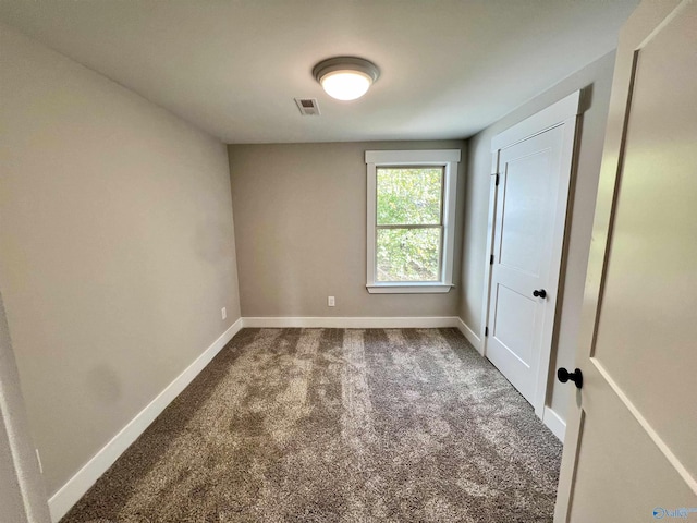 2061 Lindsay Ln S, Athens, AL 35613 - unfurnished bedroom with visible vents, dark carpet, and baseboards