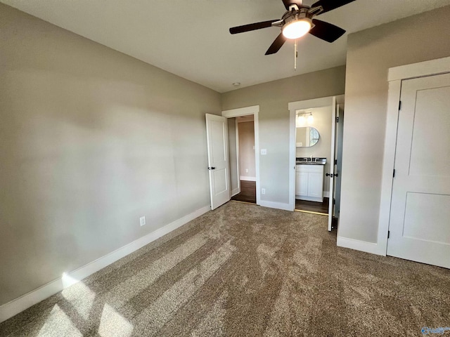 2061 Lindsay Ln S, Athens, AL 35613 - unfurnished bedroom featuring dark carpet, ceiling fan, connected bathroom, and baseboards