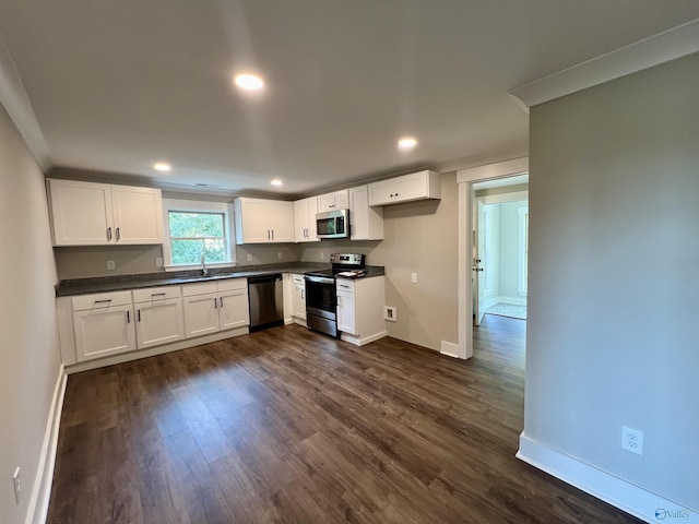 2061 Lindsay Ln S, Athens, AL 35613 - kitchen featuring a sink, dark wood-style flooring, stainless steel appliances, baseboards, and dark countertops