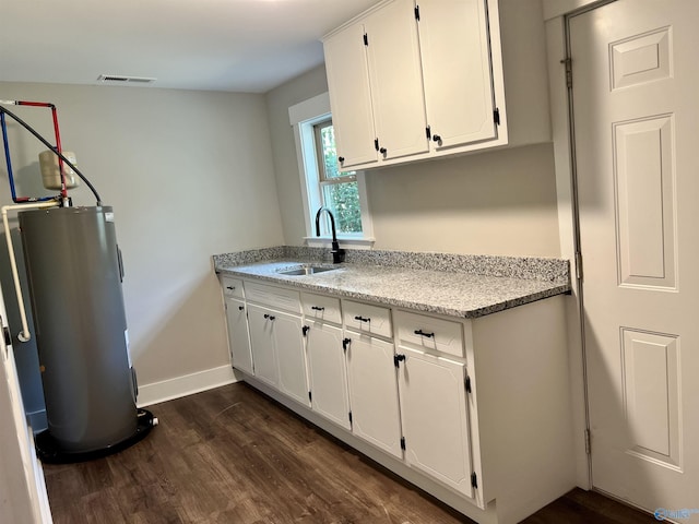 2061 Lindsay Ln S, Athens, AL 35613 - kitchen with a sink, electric water heater, visible vents, white cabinets, and dark wood finished floors