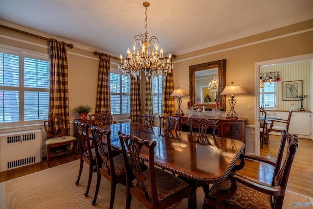 260 Bexar Ave W, Hamilton, AL 35570 - dining room featuring radiator, a healthy amount of sunlight, a chandelier, and wood finished floors