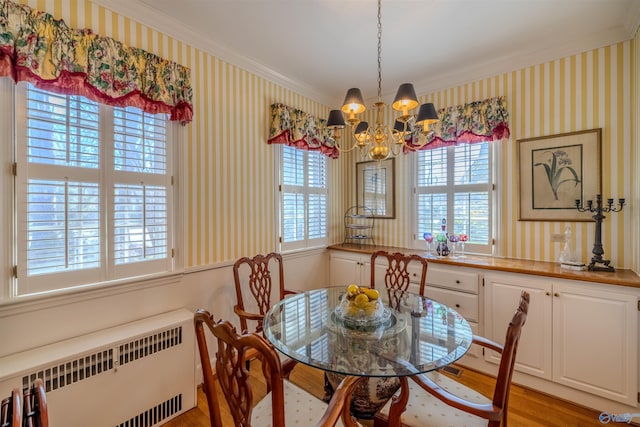 260 Bexar Ave W, Hamilton, AL 35570 - dining space featuring wallpapered walls, light wood-style flooring, radiator heating unit, and an inviting chandelier