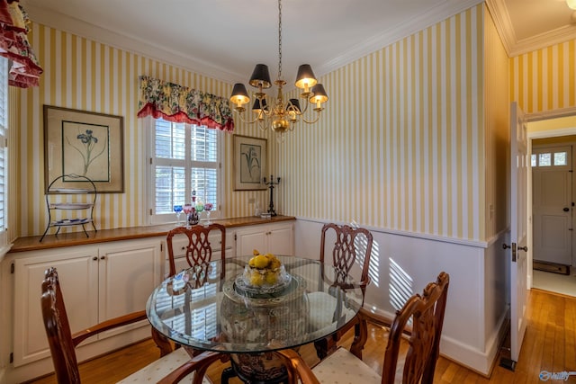 260 Bexar Ave W, Hamilton, AL 35570 - dining room with crown molding, light wood-type flooring, a chandelier, wallpapered walls, and wainscoting