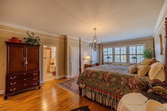 260 Bexar Ave W, Hamilton, AL 35570 - bedroom with crown molding, baseboards, light wood-type flooring, ensuite bath, and an inviting chandelier