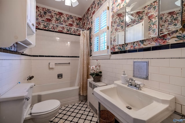 260 Bexar Ave W, Hamilton, AL 35570 - bathroom featuring tile walls, wallpapered walls, toilet, a ceiling fan, and a sink