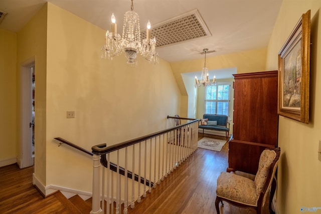 260 Bexar Ave W, Hamilton, AL 35570 - stairway featuring baseboards, visible vents, wood finished floors, and an inviting chandelier