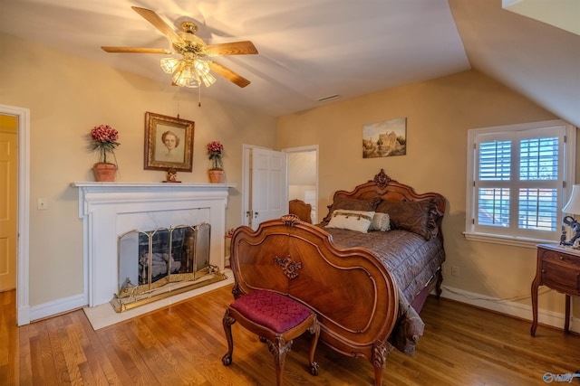 260 Bexar Ave W, Hamilton, AL 35570 - bedroom featuring visible vents, baseboards, a premium fireplace, and wood finished floors