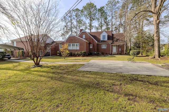260 Bexar Ave W, Hamilton, AL 35570 - view of front of house with brick siding, a detached carport, and a front lawn