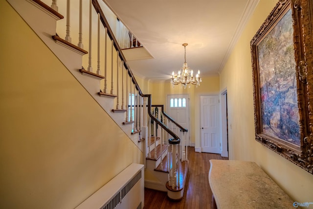 260 Bexar Ave W, Hamilton, AL 35570 - foyer entrance featuring stairs, an inviting chandelier, dark wood-style flooring, ornamental molding, and radiator heating unit