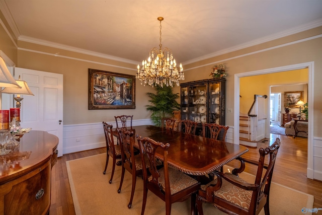 260 Bexar Ave W, Hamilton, AL 35570 - dining room with wainscoting, light wood-type flooring, ornamental molding, and an inviting chandelier