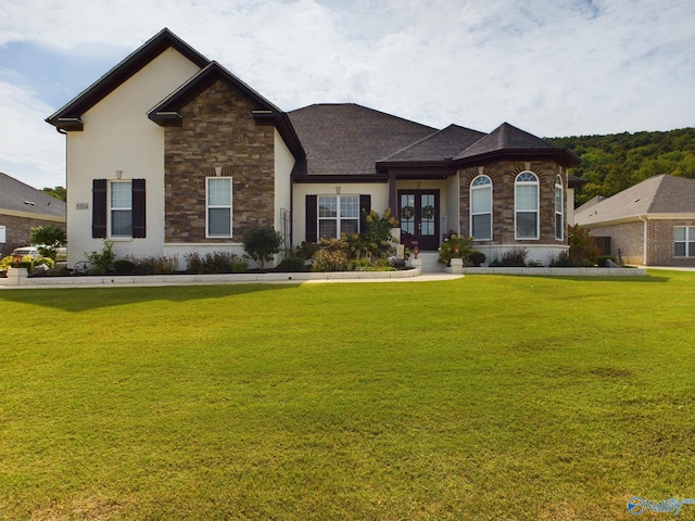 view of front of house featuring a front lawn and french doors