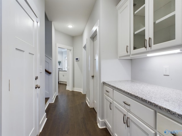 corridor with dark hardwood / wood-style floors