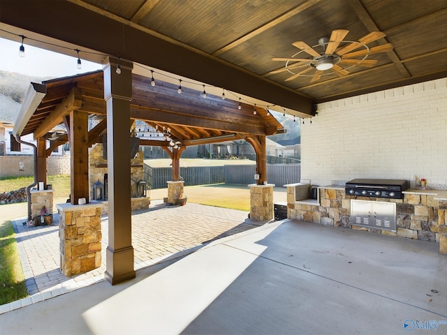 view of patio with a gazebo, area for grilling, ceiling fan, and a grill