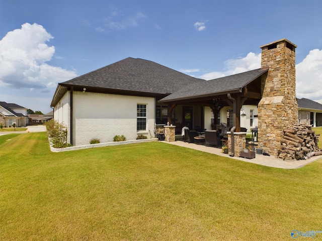 back of house with a lawn, a patio area, and an outdoor living space