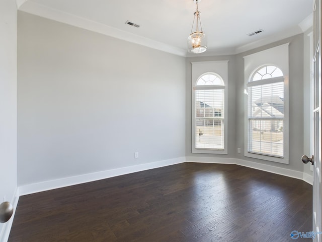 unfurnished room with dark hardwood / wood-style flooring, ornamental molding, and a notable chandelier