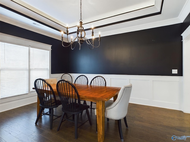 dining room with crown molding, dark wood-type flooring, and a chandelier