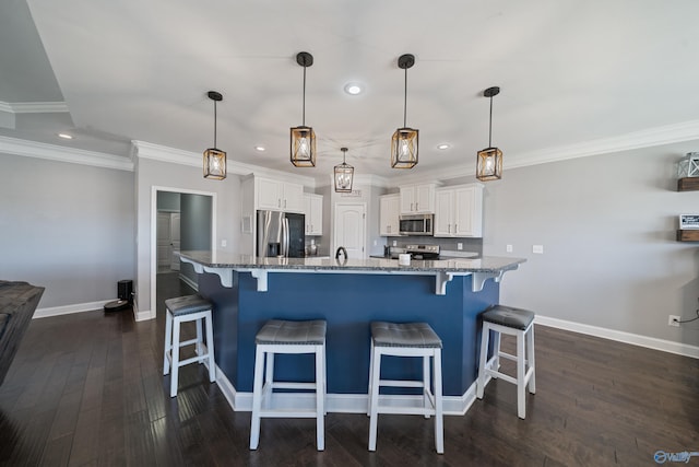 kitchen with baseboards, appliances with stainless steel finishes, white cabinetry, and recessed lighting