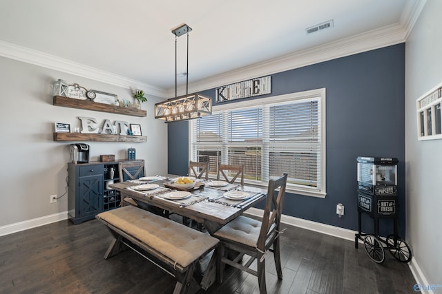 dining room featuring baseboards, visible vents, a chandelier, and ornamental molding