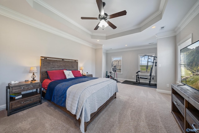 carpeted bedroom featuring baseboards, ornamental molding, a tray ceiling, and recessed lighting