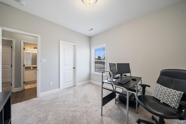 office space with visible vents, baseboards, and carpet flooring