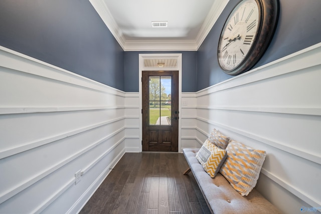 entryway with dark wood-style flooring, crown molding, a wainscoted wall, and visible vents