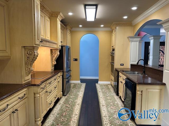 752 12th Way NE, Arab, AL 35016 - kitchen with cream cabinets, arched walkways, a sink, and ornate columns
