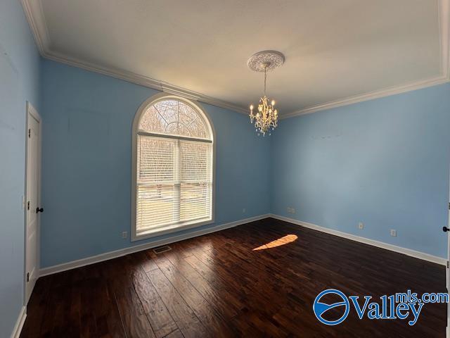 752 12th Way NE, Arab, AL 35016 - empty room featuring a chandelier, hardwood / wood-style floors, baseboards, and ornamental molding