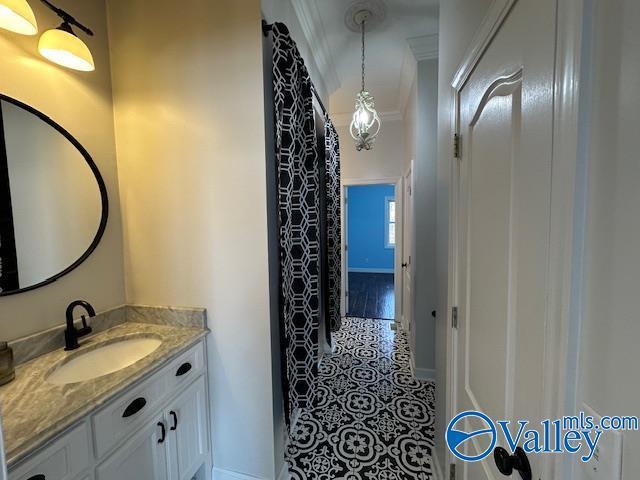 752 12th Way NE, Arab, AL 35016 - bathroom with tile patterned floors, baseboards, vanity, and crown molding