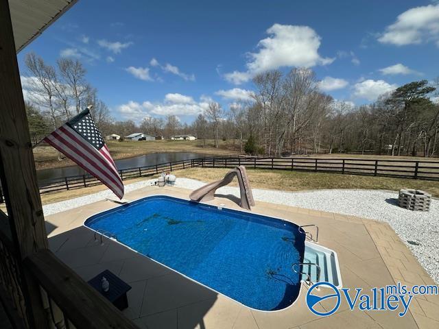 752 12th Way NE, Arab, AL 35016 - view of pool featuring a fenced in pool, a water slide, fence, a water view, and a patio