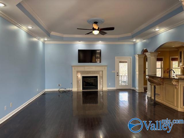 752 12th Way NE, Arab, AL 35016 - living area with arched walkways, a premium fireplace, dark wood-type flooring, crown molding, and ceiling fan