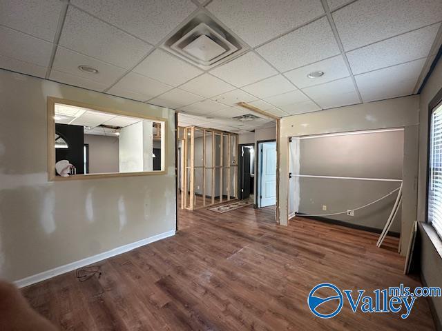 752 12th Way NE, Arab, AL 35016 - empty room with wood finished floors, baseboards, a paneled ceiling, and visible vents