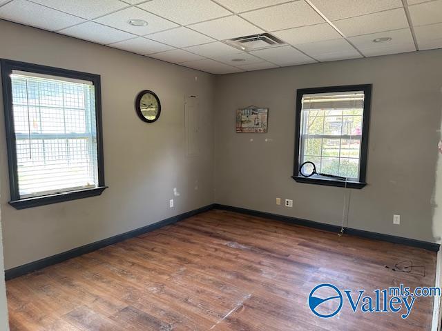 752 12th Way NE, Arab, AL 35016 - empty room featuring baseboards, visible vents, wood finished floors, and a drop ceiling