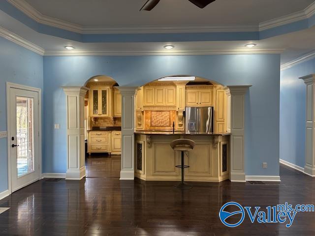 752 12th Way NE, Arab, AL 35016 - kitchen featuring dark wood finished floors, stainless steel fridge with ice dispenser, baseboards, and decorative columns