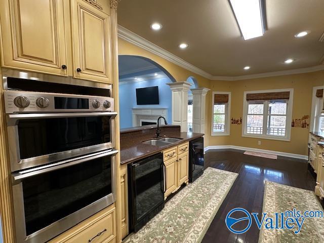 752 12th Way NE, Arab, AL 35016 - kitchen featuring crown molding, beverage cooler, stainless steel double oven, and a sink