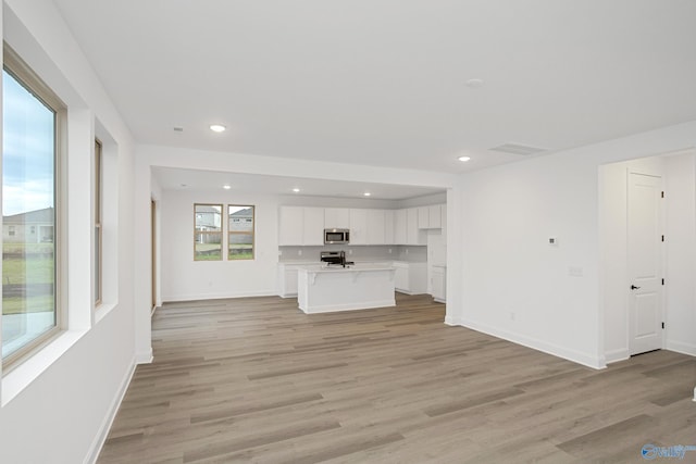 unfurnished living room featuring light hardwood / wood-style flooring