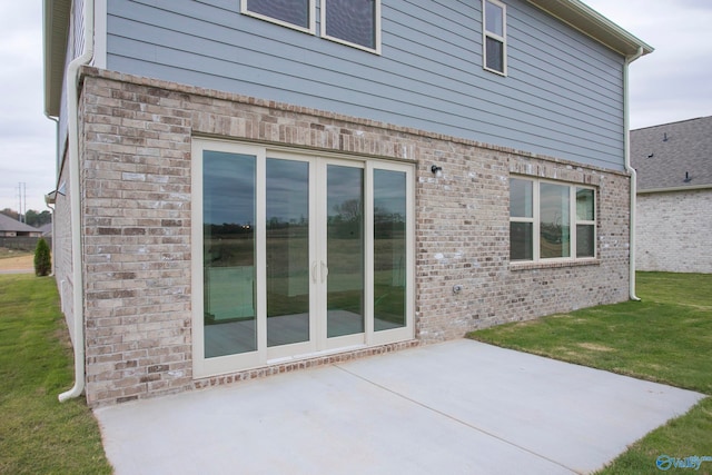 view of property exterior featuring a patio and a lawn