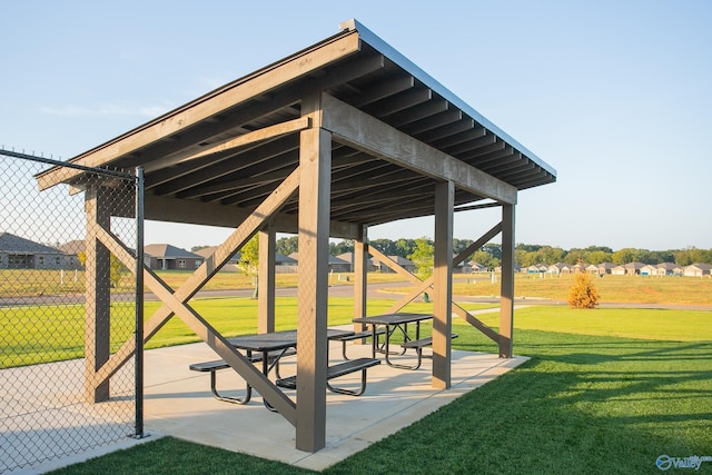 view of home's community featuring a patio and a lawn