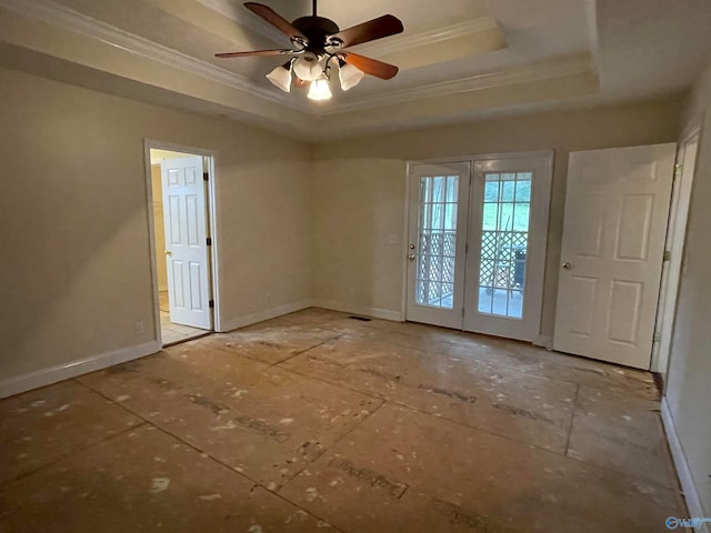 unfurnished room with ceiling fan, a raised ceiling, french doors, and ornamental molding