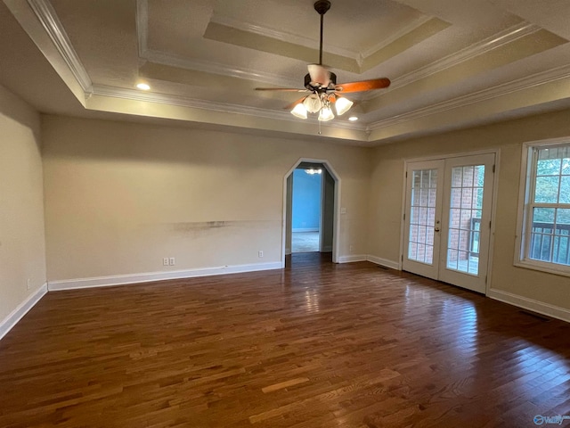 spare room with ornamental molding, french doors, dark hardwood / wood-style floors, and a raised ceiling