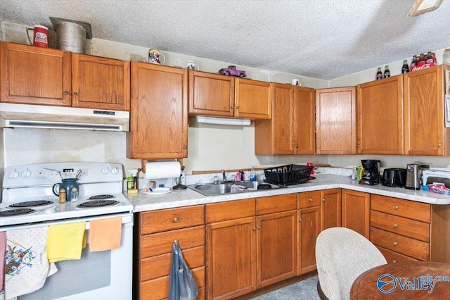 kitchen with white electric range oven, sink, and a textured ceiling