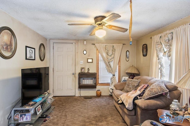 carpeted living room featuring a textured ceiling, heating unit, plenty of natural light, and ceiling fan