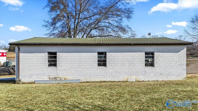 view of side of home with a lawn