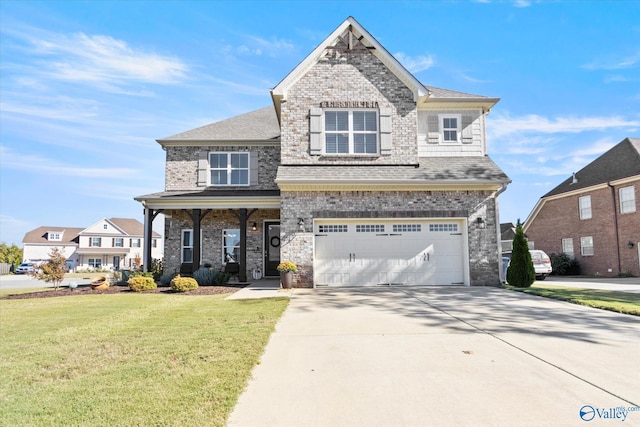 view of front of home featuring a front yard and a garage