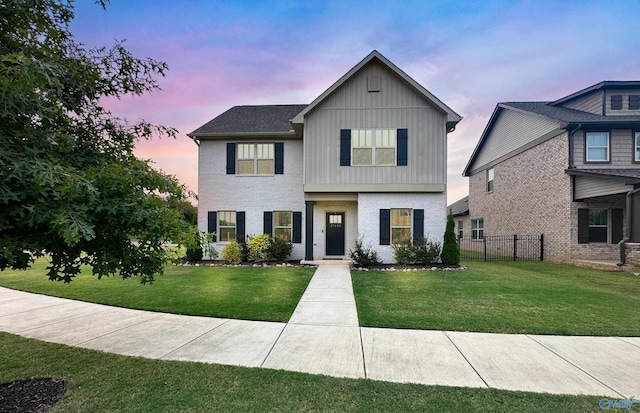view of front of home featuring board and batten siding and brick siding