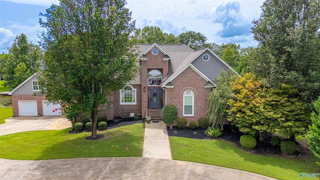 view of front of house with a garage and a front yard