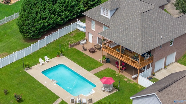 view of pool featuring a patio area and a yard