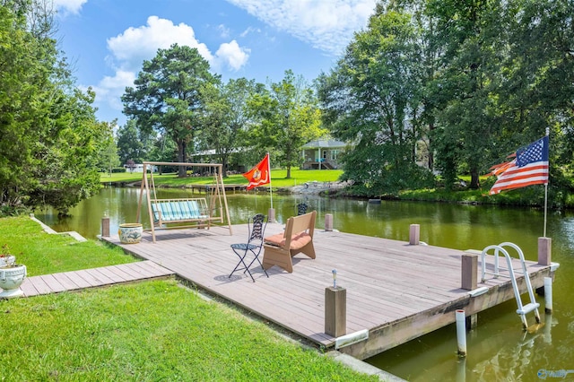 view of dock with a water view and a lawn