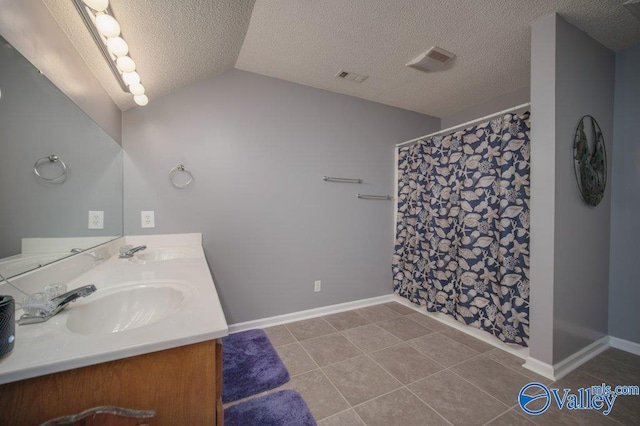 full bathroom featuring vaulted ceiling, visible vents, a sink, and double vanity