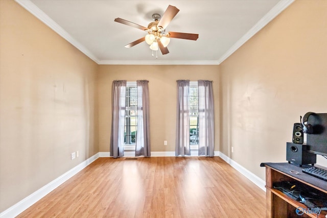 interior space featuring light wood-style flooring, baseboards, and crown molding